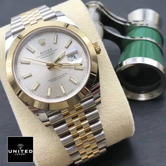 Rolex Datejust 126303-0002 Yellow Gold Super Accurate Clone rolex datejust 41 gold unitedluxury Rolex Datejust 41 126303-0002 Replica watch on cushion on the table
