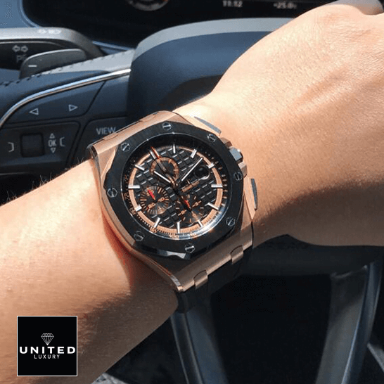 Audemars Piguet Black Bezel Replica on the steering wheel on a man's wrist