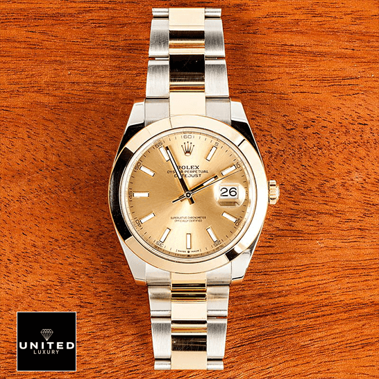 Rolex Datejust 126303 Two-Tone Premium Copy 1:1 Rolex Datejust 126303 Gold Dial Replica on a wooden table