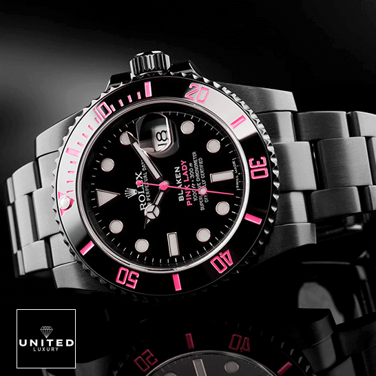 Rolex Submariner 116610N Rolex Blaken Submariner Pink Bezel and Black Dial on the table